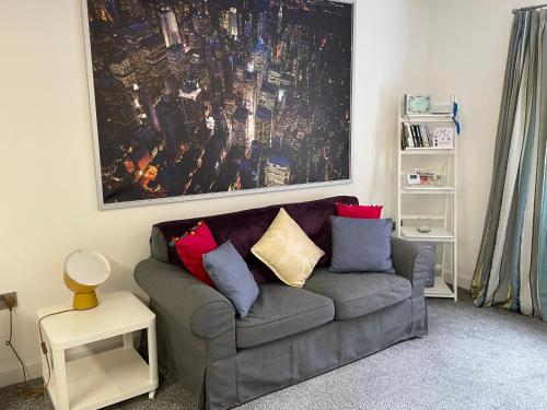 a living room with a couch with pillows on it at Fabulous One Bedroom Apartment in Ripon City Centre in Ripon