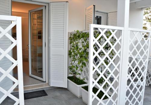 a white fence in front of a house at Arneo Terra del Sole in Torre Lapillo