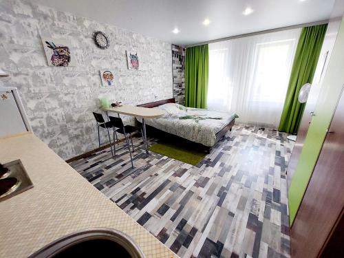 a room with a table and a bed in it at Апартаменты СВ "Атлант" in Tver
