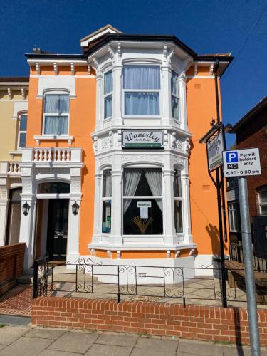 a orange and white building with a sign in front of it at Waverley Park Lodge in Portsmouth