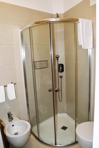 a shower in a bathroom with a toilet and a sink at Arneo Terra del Sole in Torre Lapillo