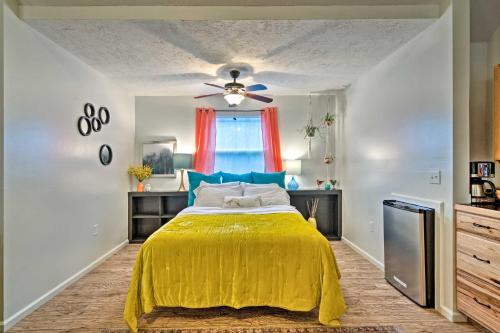 a bedroom with a yellow bed with a ceiling fan at Bright Lakeside Studio - Hike, Fish, and Bike! in Golden