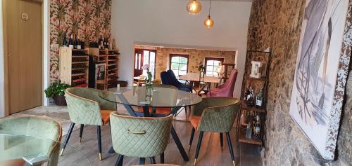 a dining room with a glass table and chairs at Ecocasa Lema II in Muxia