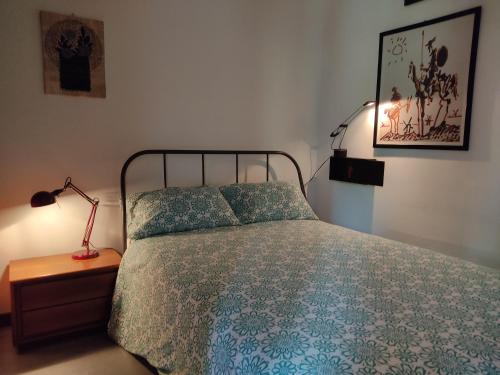 a bedroom with a bed and a lamp on a night stand at Da Ramona in Iseo