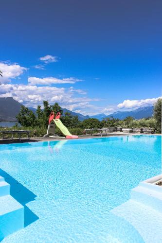a swimming pool with a slide in the middle at Villa Elena appartamento in villa in Montinelle