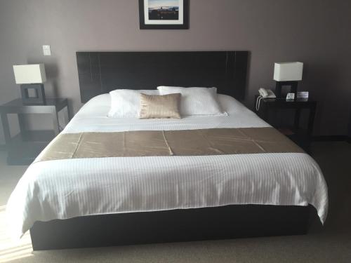 a bedroom with a large bed with white sheets and pillows at TIERRA VIVA in Comitán de Domínguez