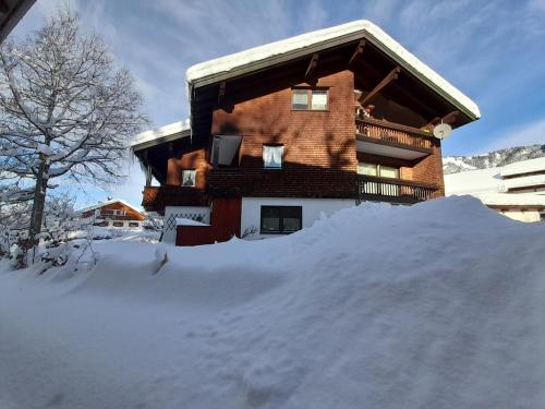 a snow pile in front of a building at Landhaus Schanzblick in Bad Hindelang