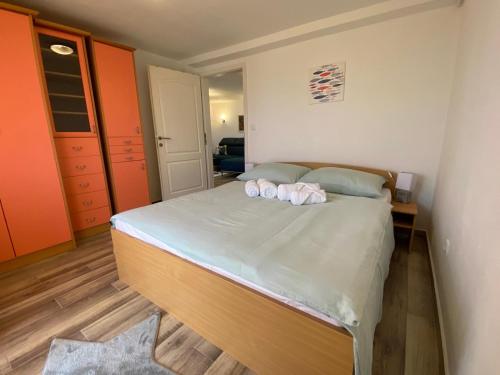 a bedroom with a bed with two towels on it at Apartman Veronika in Risika