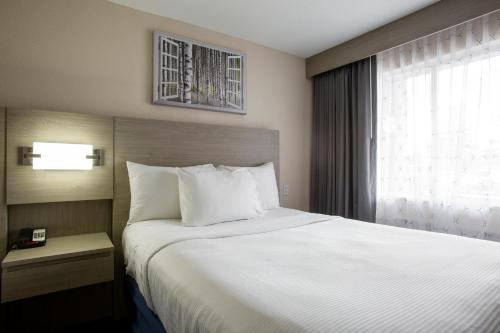Un pat sau paturi într-o cameră la Hotel Aspen Flagstaff/ Grand Canyon InnSuites