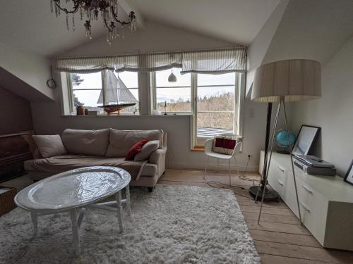 a living room with a couch and a table at Villa Myttinge in Värmdö