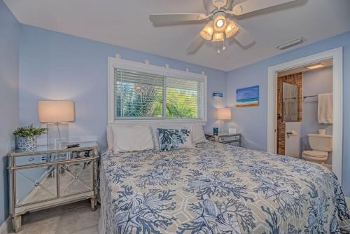 a bedroom with a bed and a ceiling fan at Salt Air East by Beach Retreats in Holmes Beach