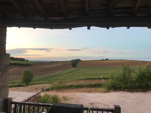 a view of a green field from a window at les gîtes d'en Julio in Puylaurens