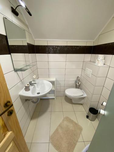 a bathroom with a sink and a toilet at Le Ranch in Cernik