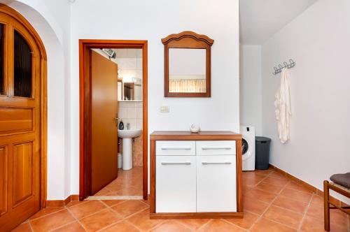een badkamer met een wastafel en een spiegel bij House Ulika in Bale