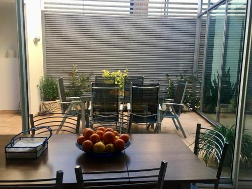 a wooden table with a bowl of fruit on it at Casa de pueblo amplia in Sa Pobla