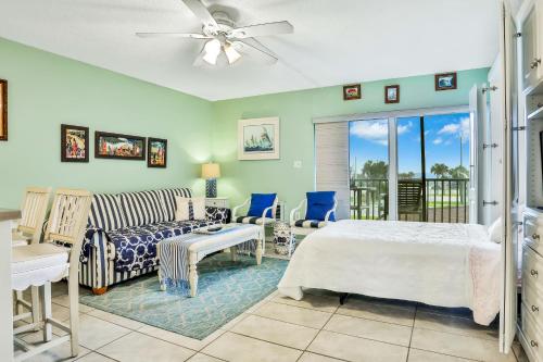 a living room with a bed and a couch at Mariners Cove 302 in New Smyrna Beach