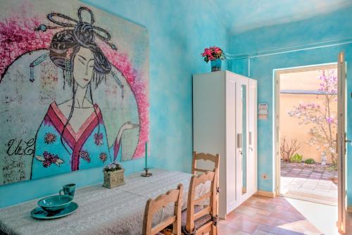 a dining room with a painting of a woman on the wall at Lotus apartment in Szentendre