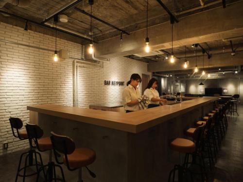 two people standing at a bar in a restaurant at SHIRAHAMA KEY TERRACE SEAMORE RESIDENCE - Vacation STAY 35166v in Kanayama