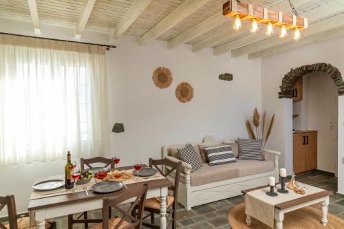 a living room with a couch and a table at Naxian Icon Luxury Residence in Naxos Chora