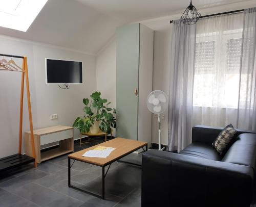 a living room with a couch and a table at Oleander Hof in Hochstadt