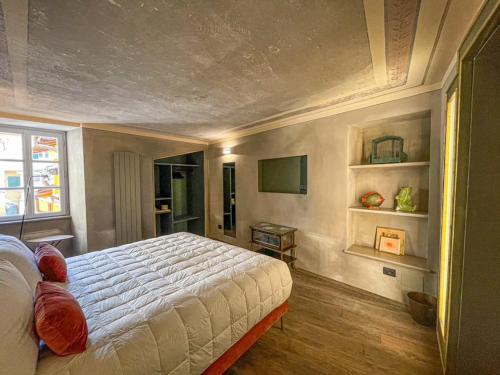 a bedroom with a large bed and a window at DIMORA SCURONE in Cannobio