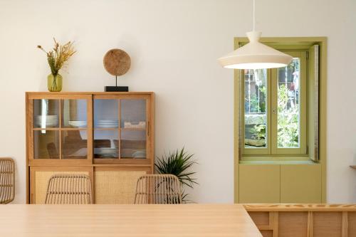 a dining room with a table and a cabinet at Casa da Gueira in Vale de Cambra