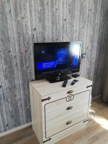 a tv on top of a dresser with a drawer at Ленина 31 in Omsk