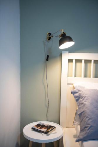 a room with a bed with a table and a light at Palmeira Studio in Preveza