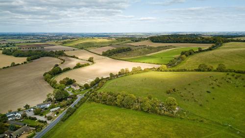 an aerial view of a field with a river at Aspen, Country Chalet located In Pegsdon in Hexton