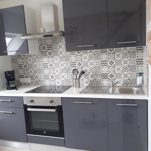 a kitchen with a sink and a counter top at Appartement à la campagne in Noyal-Muzillac