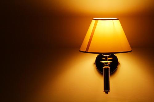 a lamp attached to a wall with a light on it at Hotel Villa Pigna in Ascoli Piceno