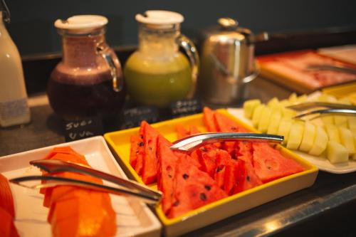 a plate of food with fruits and vegetables on a counter at Hotel Euro Suite Curitiba Batel By Nacional Inn in Curitiba