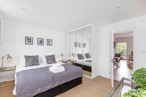a bedroom with a bed and a large mirror at Lovely 1-Bed Apartment in London in London