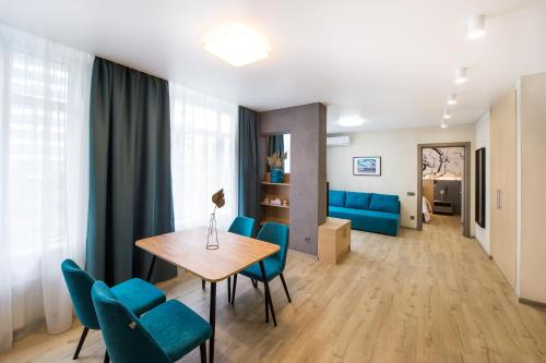 a living room with a table and chairs at ORION apartments in Kyiv
