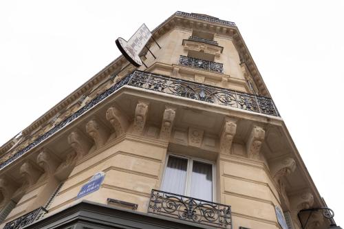 a building with a clock on the top of it at Hotel & Spa Saint-Jacques in Paris