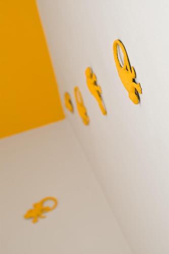 a group of yellow scissors on a white wall at Es Mitjorn Hotel in San Antonio
