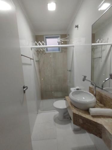 a bathroom with a toilet and a sink and a shower at Pousada Vistazul - Pé na Areia in Bertioga