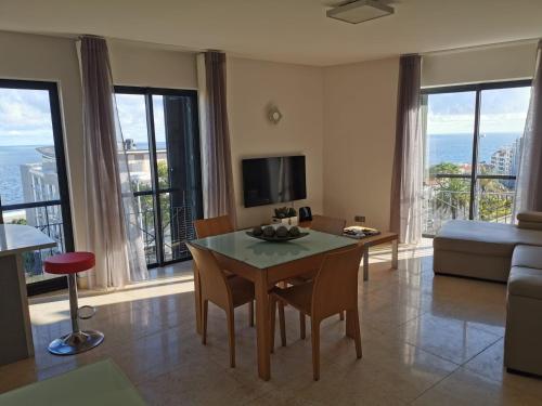 a living room with a table and a couch at Sun Island Apartments in Funchal