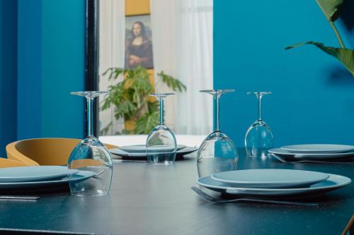 a table with plates and wine glasses on it at Appartements - Centre Ville in Rabat