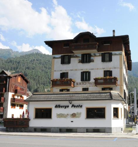 a building with a sign that reads happy rent at Hotel Posta in Aprica