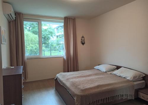 una camera da letto con un letto e una grande finestra di Apartment Relax Lozenets a Lozenets
