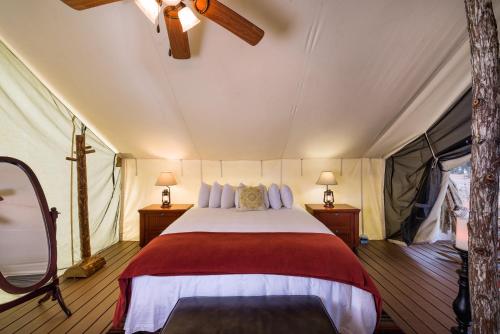 a hotel room with a bed, table, lamps and a canopy at Westgate River Ranch Resort & Rodeo in River Ranch