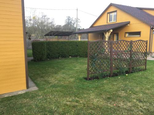 a fence in front of a yellow house at Rojas Rodes in Roja