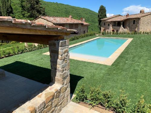 a garden with a swimming pool and a house at Villa Pie Vecchia in Greve in Chianti