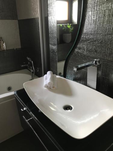 a bathroom with a white sink and a mirror at Goa Central apartament in Drobeta-Turnu Severin