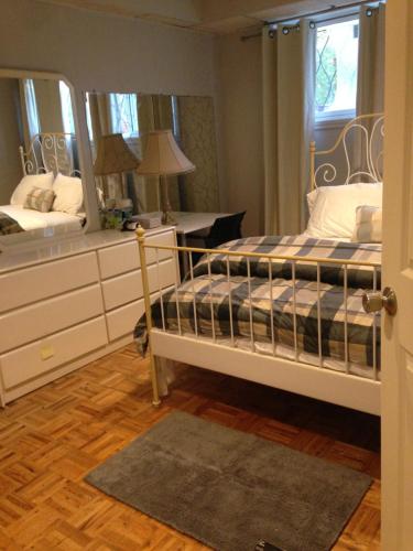 a bedroom with two bunk beds and a mirror at Apt Near Downtown in Montreal