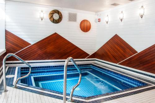a swimming pool with a blue tub and a blue floor at Charltons Banff in Banff