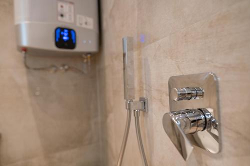 a shower with a camera on the wall of a bathroom at Shushi's Central Studio Apartment in Plovdiv