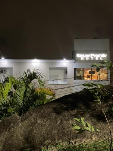 a white building with a sign on it at night at Barueri Premiêr Hotel in Barueri