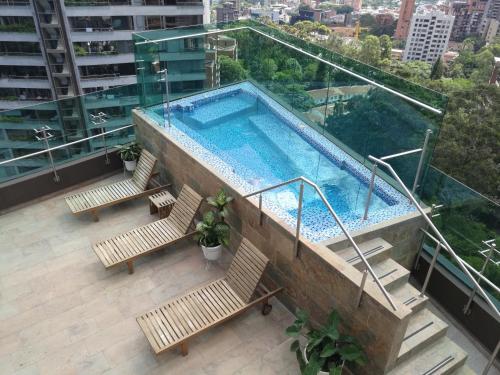 a swimming pool on top of a building at Café Hotel Medellín in Medellín